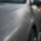 Close-up view of a grey car with visible scratches on the surface