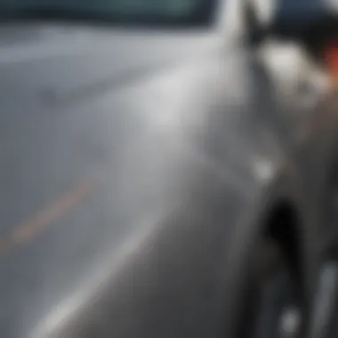 Close-up view of a grey car with visible scratches on the surface