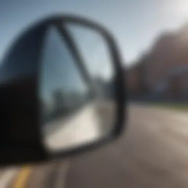 Close-up view of a broken side view mirror showing shattered glass and cracks