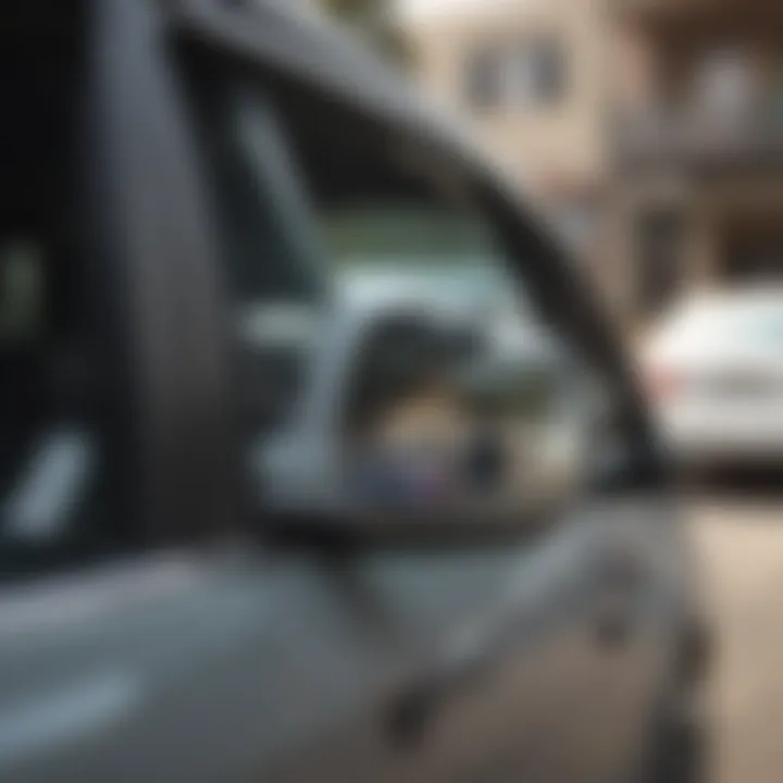 A side view mirror being carefully reattached to a vehicle with adhesive