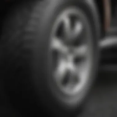 Close-up of vehicle tires showing uneven wear due to misalignment